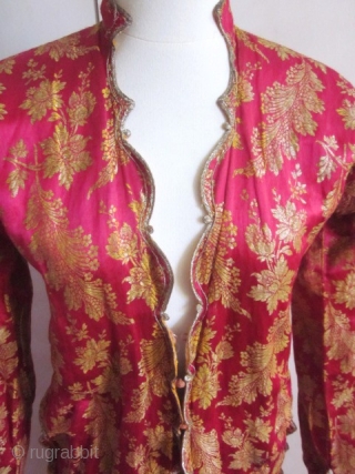 Fushia and gold brocaded satin silk Bindalli from Ottoman Empire late 19c early 20c. Usually used for ceremonial event . Beautiful brocaded fuchsia satin with gold thread and floral garlands, entirely piped  ...