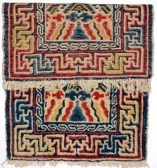 Above-saddle carpet woven in the Ningxia region of China in the early 1900’s. The main border consist of interlinked swastikas, while the inner border features a single key meander. At either end  ...