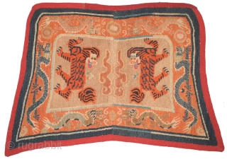 The portrayal of a tiger was a powerful symbol of high rank in Tibet with both the secular upper class and the religious class using weaving's depicting them. This Tibetan 'butterfly' shaped  ...