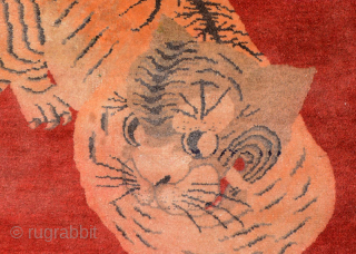 Impressive tiger carpet from the Inner Mongolian region of China. The tiger is very well rendered against a red background and is shown in the classic ‘paw on paw’ stance and a  ...