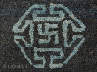 Very attractive Tibetan blue seating carpet with seven small mandala-like ‘medallions’ floating in the main field, each enclosing an auspicious swastika or sauswastika (i.e. a reverse swastika), with a 'T' shaped meander  ...