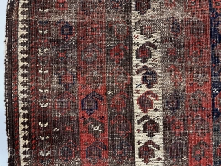 Early Baluch rug with interesting and archaic striped or “cane” design. Overall very rough with areas of foundation exposed and no pile. All natural colors including an excellent saturated red. Remnant original  ...