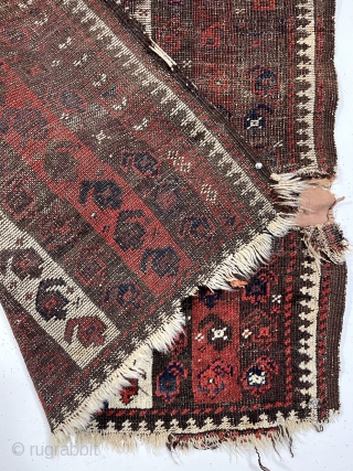 Early Baluch rug with interesting and archaic striped or “cane” design. Overall very rough with areas of foundation exposed and no pile. All natural colors including an excellent saturated red. Remnant original  ...