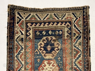 Early Kazak rug. Classic design elements. All natural colors. Charming border drawing. Obviously not for the condition collector. Rips, tears, holes, creases and more. Structurally ok. Red abrashed to light yellow at  ...