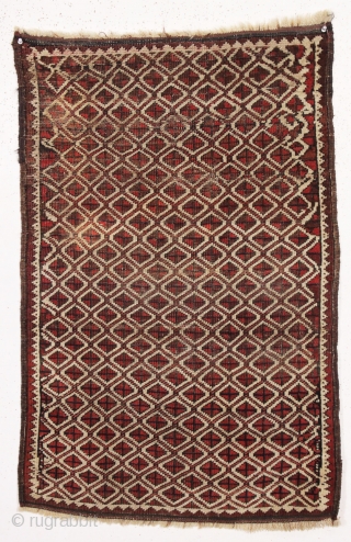 Antique tiny Baluch rug with an unusual allover design. All natural colors. "as found", with some wear as shown but original sides and ends. Reasonably clean with a small old stain as  ...