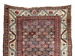 Antique tribal pile rug in good condition with some unusual design features. Possibly Veramin? Overall good medium length pile with very light wear. The dark blue field densely packed with latch hooked  ...