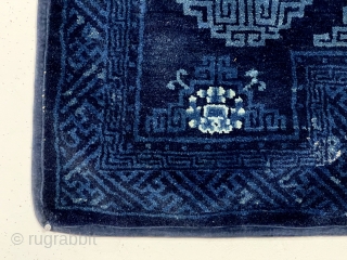 Beautiful antique Chinese saddle rug. Attractive rich indigo blue color and vibrant highlights. Overall mostly good thick lustrous pile. Old cloth backing, probably original. Reasonably clean. Late 19th c.  2’3”x 4’7” 