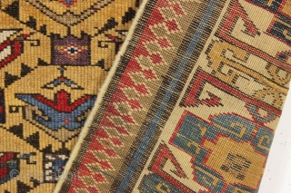 antique mustard yellow ground caucasian rug in good condition. Serrated lattice with large tulip palmettes and an unusually colorful wide ivory kufic main border. Overall nice even medium pile with slight brown  ...