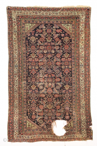 Antique ferrahan rug with interesting design elements but unfortunately damaged by a cannonball. All good colors featuring that nice characteristic apple green. Many little animals and charming humans. Selling "as found", very  ...