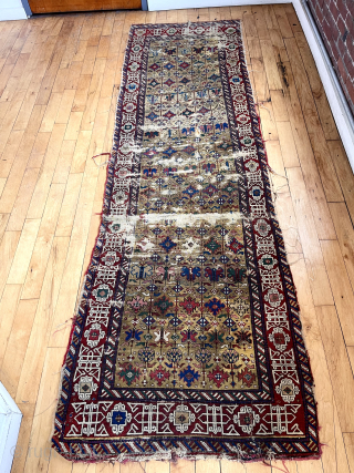 If only the entire rug was like this. Early east Caucasian long rug with lovely deep yellow ground. Unfortunately areas of very heavy wear and damages. Edges all rough as shown. Soft  ...