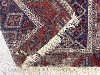 Antique Baluch rug with an uncommon “c gul” field. Acquired many years ago from a well known Providence collector. Not in great condition, holes and wear, but has presence. 19th c. 43”  ...