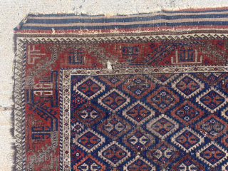 Antique Baluch rug with an uncommon “c gul” field. Acquired many years ago from a well known Providence collector. Not in great condition, holes and wear, but has presence. 19th c. 43”  ...