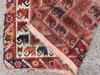 Early little Turkish rug. West Anatolian? Archaic design. Great border. Beautiful colors. Some decent pile but also heavy wear with holes as shown. Nearly square. Reasonably clean. One of my favorite little  ...