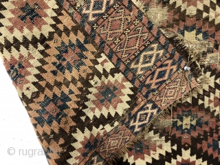 Antique unusual turkman rug fragment, perhaps chodor, with a tight lattice of ashik guls arranged in diagonal color rows on a dark brown ground. Persian knotted open to the right. Appears to  ...