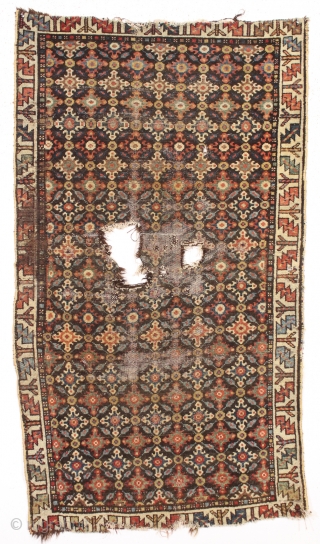 early northwest persian, or perhaps veramin rug remains. Not for everyone but to me a fascinating archaic field design with what I assume are cloudband derived motifs. Beautiful natural colors. As found,  ...