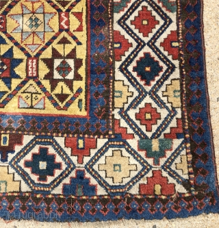 Early yellow ground Caucasian long rug with some unusual design features and excellent saturated natural colors. Kazak? Gendge? Eye catching uncommon ivory border. Unfortunately damaged with a large tear as shown. As  ...