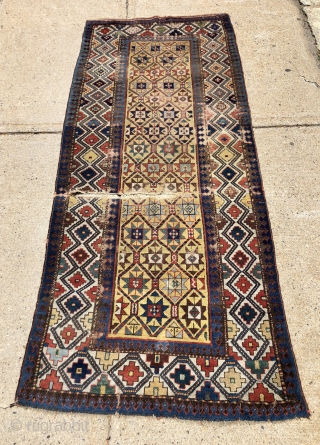 Early yellow ground Caucasian long rug with some unusual design features and excellent saturated natural colors. Kazak? Gendge? Eye catching uncommon ivory border. Unfortunately damaged with a large tear as shown. As  ...