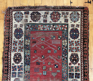 Early Caucasian rug with some usual and some unusual design features. Talish group long narrow format with iconic endless knot and “dice” elements. The additional quirky field decoration makes this a unique  ...