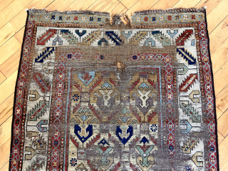 Early Caucasian long rug with a rich yellow ground and floral palmette lattice. Probably described as “gendge” for lack of a better name. Intact but with some heavy wear and exposed foundation.  ...