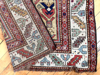 Early Caucasian long rug with a rich yellow ground and floral palmette lattice. Probably described as “gendge” for lack of a better name. Intact but with some heavy wear and exposed foundation.  ...