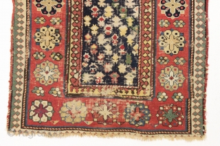 Antique caucasian rug. Early example in abused condition. An interesting design with all natural colors (no fuchsine). Grandma worked overtime flat stitching this beauty, filling in substantial sections by candlelight no doubt.  ...