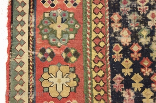 Antique caucasian rug. Early example in abused condition. An interesting design with all natural colors (no fuchsine). Grandma worked overtime flat stitching this beauty, filling in substantial sections by candlelight no doubt.  ...