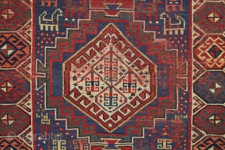 antique kazak with an unusual, if not unique design. The center reserve seems to be a diminutive version of a well known design but the surrounding field is quite eyecatching and inventive.  ...