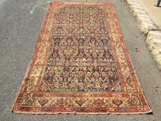 What remains of a genuine antique Persian ferrahan rug. Thin with overall very low pile. Tears, holes and scattered old repairs as shown. Pretty apple green border. Not restorable, good for patches  ...