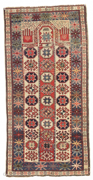 antique caucasian prayer rug with an unusual and interesting design. Eye catching large red hands and big scale columnar, totemic field. All natural colors. As found, with overall mostly even low pile,  ...