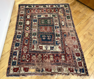 Out of the cedar chests. Early compartment Kazak with great borders. Fine old colors including real purples. Not perfect condition. Mid 19th c. 4’10” x 6’6”       