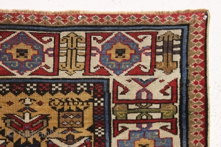 antique yellow ground caucasian gendge rug. Nicely drawn large tulip palmettes and an unusually colorful kufic border. Overall good condition with even medium pile. All natural colors including nice greens, light blues,  ...