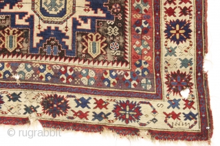 antique caucasian rug, probably kuba, with bold lesghi stars and the complex drawing that indicates good age. As found, mostly good pile elements on a very corroded brown ground. Some scattered damage  ...