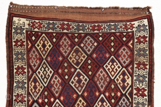 Antique tribal mystery rug. Charming little rug with a kurdish type diamond lattice design, complete with offset knotting in the field area. The overall color palette appears more veramin or luri to  ...