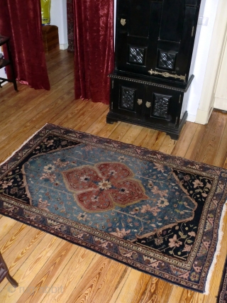 Serapi, blue field, medium sized ( 190x128 cm ). Over 100 yrs old ( survived the 2nd WW in a Berlin household) this rug shows signs of wear: selvages partly folded, many  ...