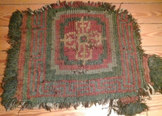 Tibetan 'warp face back' rug-fragment from monastic origins with a pure crossed Vajra symbol. An ancient piece that requires delicate handling, acquired in China. Fragment's size: 75x50 cm.     