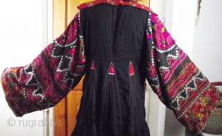 Exceptionally fine Kohistani dress called a jumlo, decorated with silk embroidery, mother of pearl buttons silver coins and amulets. Please email for more information or to arrange a viewing.
    
