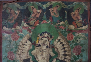 A very unusual Nepalese or perhaps East Tibetan 19th century Buddhist thangka of Maha Cundi with eighteen arms seated on a green dragon and holding a basket of jewels with four aspara  ...