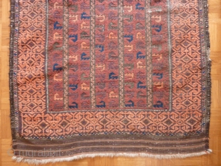 Old Baluch rug of a rare type. 
Complete with skirts. Damages to the selvedges and some wear in the field. Extraordinary complex border and appealing field including some aubergine color.
144cm x 85cm

 