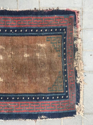 Tibetan rug, brown background with single group flower pattern, it was produced in Mid qing dynasty. Wool warp and weft. Size 75*150cm(29*58”)           