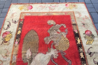 Chinese Xinjiang rug, red background with  little lion pattern, fruit veins selvage, the pronunciation of “tai Shi”, means an official position in ancient China. Good age and condition. Size 180*285cm(70*111”)  