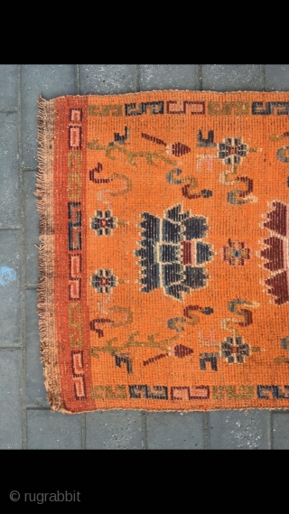 Tibetan rug, orange color with Buddha eight treasures pattern. Wool warp and weft. Size 145*73cm(56*28”)                  