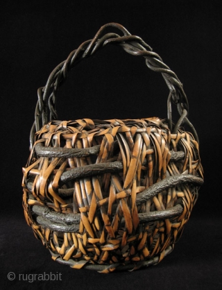 Ikebana basket, Japan.
Nemagaridake bamboo, vines.
12" wide by 15" high (30 by 38 cm).
Pre-1950.                    