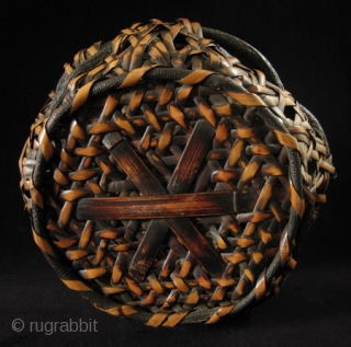 Ikebana basket, Japan.
Nemagaridake bamboo, vines.
12" wide by 15" high (30 by 38 cm).
Pre-1950.                    