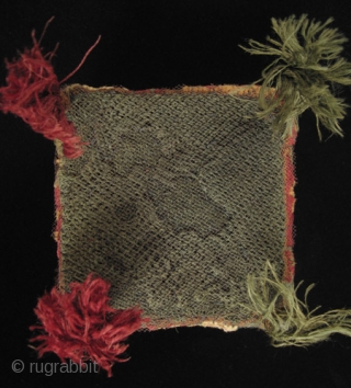 A colorful four-cornered hat from the Huari culture of the Highlands of Peru. Made of camelid wool yarns and natural dyes, it has a mesh screen on the top to contain the  ...