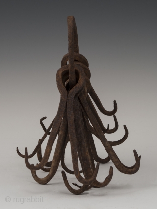 Ring of double hooks,
possibly West Africa.
Hand forged iron,
8" (20.2 cm) high,
Early to mid 20th century.

This might be an unusual type of currency or utilitarian object.        