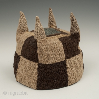 Four-cornered hat, Huari culture, Peru. Camelid fibers, natural dye.
A.D. 700-1000, 5.25" (13.3 cm) high by 5.75" (14.6 cm) diameter.
Ex. Fifi White collection, California. 	

An unusual brown and tan checkerboard four-cornered hat with  ...