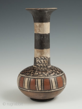 Small jar, Inca, Peru, Earthenware, 6.5" (16.5 cm) high, 1470-1550 A.D. An unusual globular terracotta jar with a tall neck, flared top and loop handle, painted on the shoulder with a stylized  ...