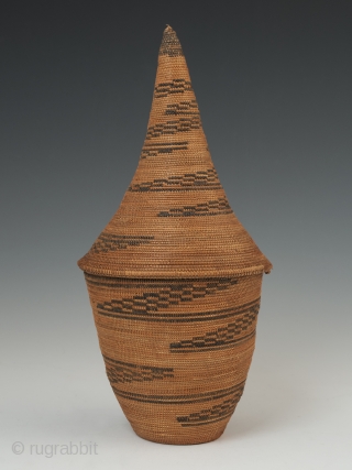 Presentation basket (Igiseke), Tutsi people, Rwanda. Plant fibers, natural dye. 8.75" (22.2 cm) high by 4" (10 cm) wide. Mid 20th century, ex. private collection, New York.

Baskets such as this often contained  ...