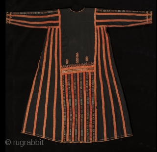 A traditional dress worn by women in the Western Desert of Egypt, this fustan is ornately decorated with thin silver coins, buttons and very fine cotton embroidery. There is a pocket on  ...