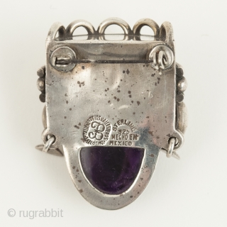 Aztec head brooch or pin, Talleres de los Ballesteros, Taxco, Mexico. Silver, amethyst, Mid-20th century. 1.75" (4.5 cm) high. A beautifully carved amethyst head of Aztec royalty set into a sterling silver  ...
